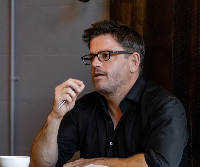 Rob Scott listening thoughtfully during a coaching session